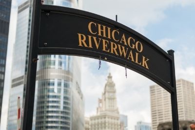 Chicago RiverWalk overhead sign, skyscrapers in the background